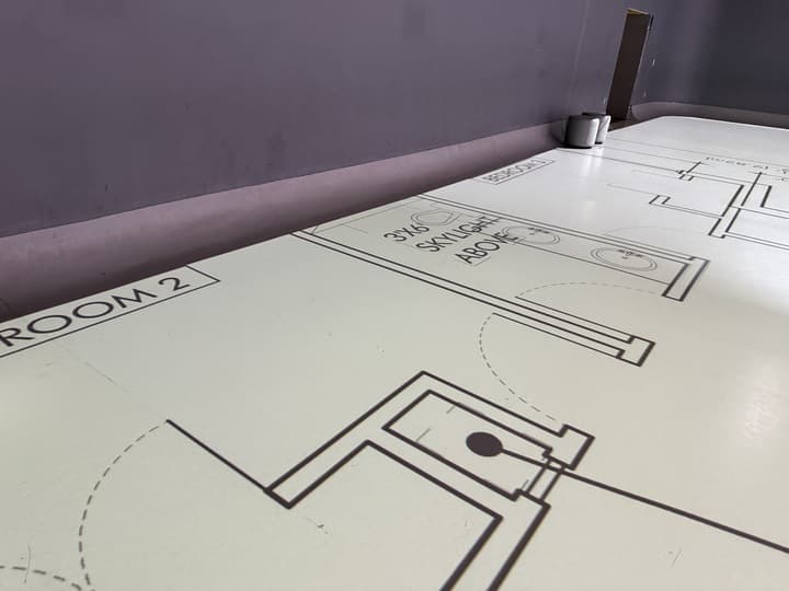 Architectural floor plans being laid out in the Levels and Lines studio
